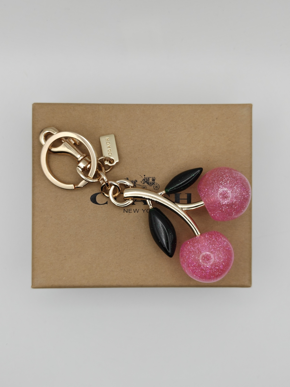 Coach Gold-Tone Pink Glitter Cherry Key Charm with Black Leaves